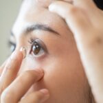 Woman inserting a contact lens