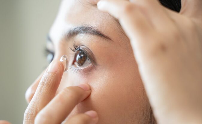 Woman inserting a contact lens